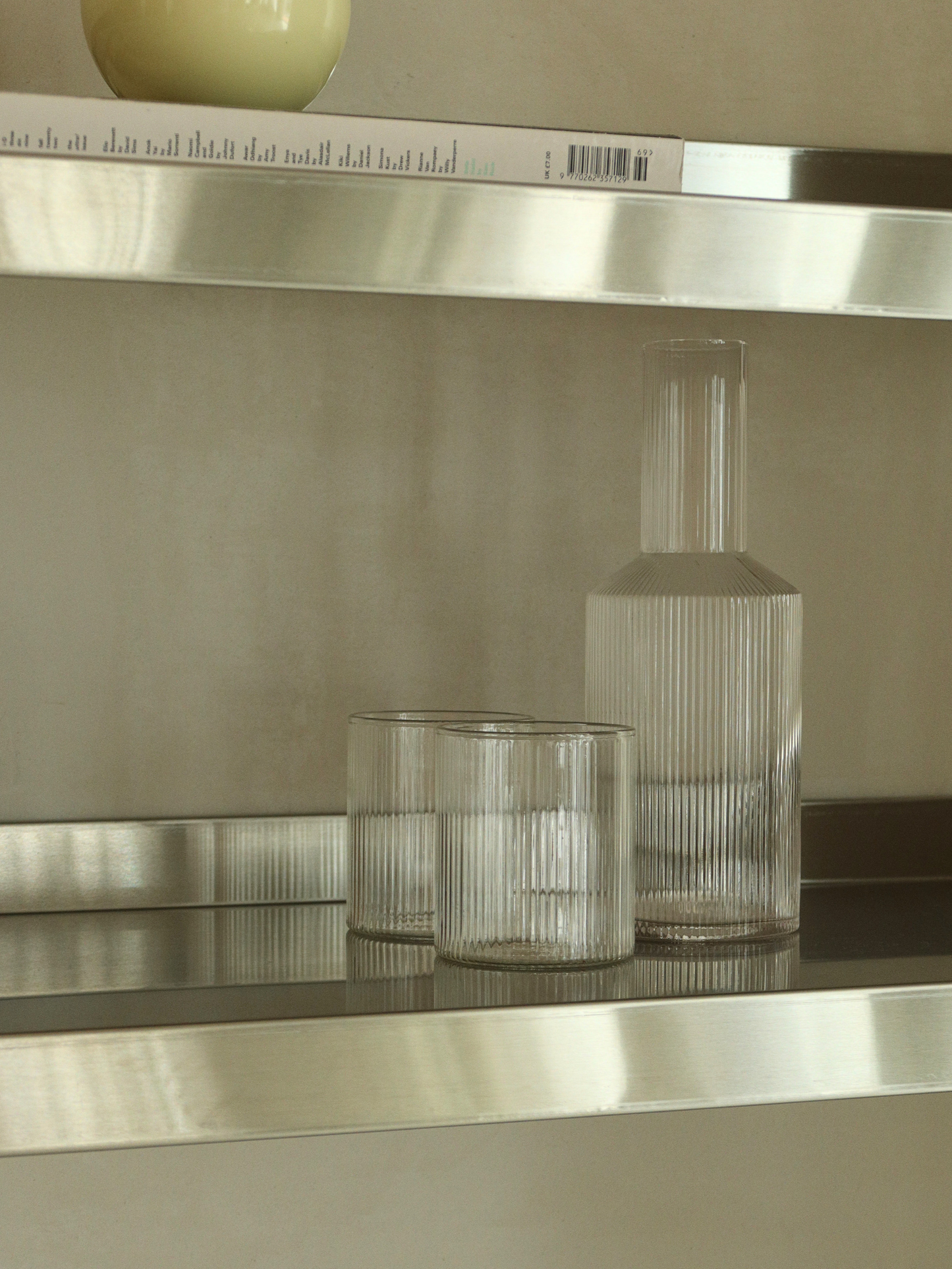 Glass water jug Neko with a subtle ribbed texture, made from clear and durable borosilicate glass. The elegant ridges beautifully catch the light, adding a refined and playful touch to the minimalist design. Perfect for serving water, juice and other refreshing drinks. The strong, heat-resistant glass and easy-to-hold shape make Neko practical for everyday use. Pair the glass jug with matching glasses for a stylish table setting, or use it on its own as an elegant water pitcher.