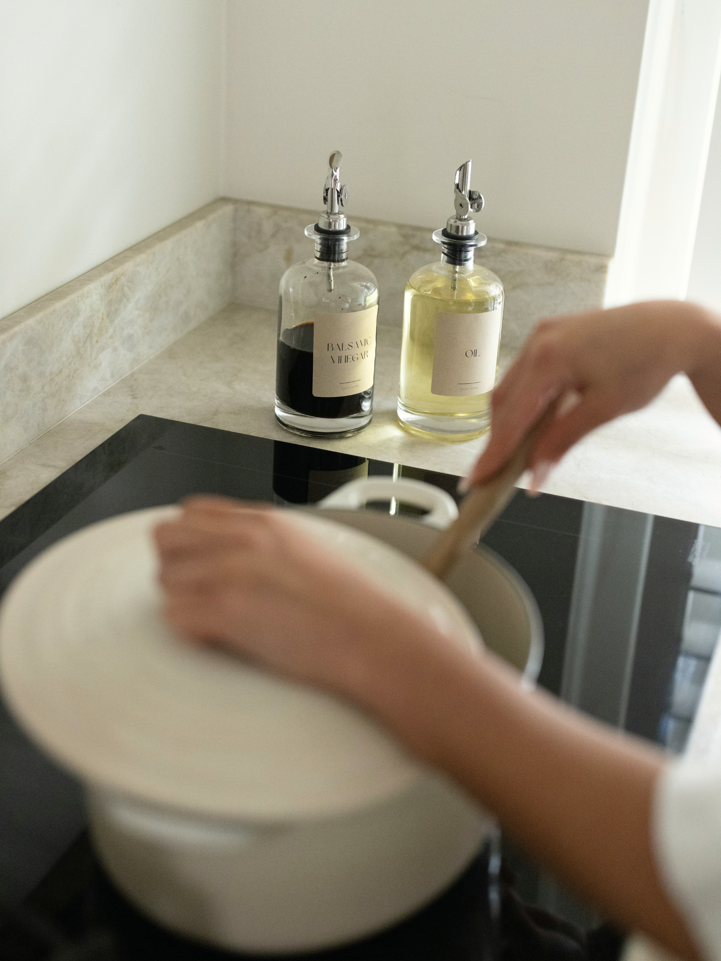 Set of two glass oil and vinegar dispensers with sleek silver caps and modern pour spouts, designed to elevate your kitchen organization. These clear, reusable bottles offer a stylish and functional way to store your favorite condiments while maintaining a clutter-free, minimalist countertop. The silver details add a refined, timeless touch that pairs beautifully with other organizing essentials from brands like Ikea, Hema, and Temu. Ideal for tidy pantries, curated kitchen zones, and sustainable home setup