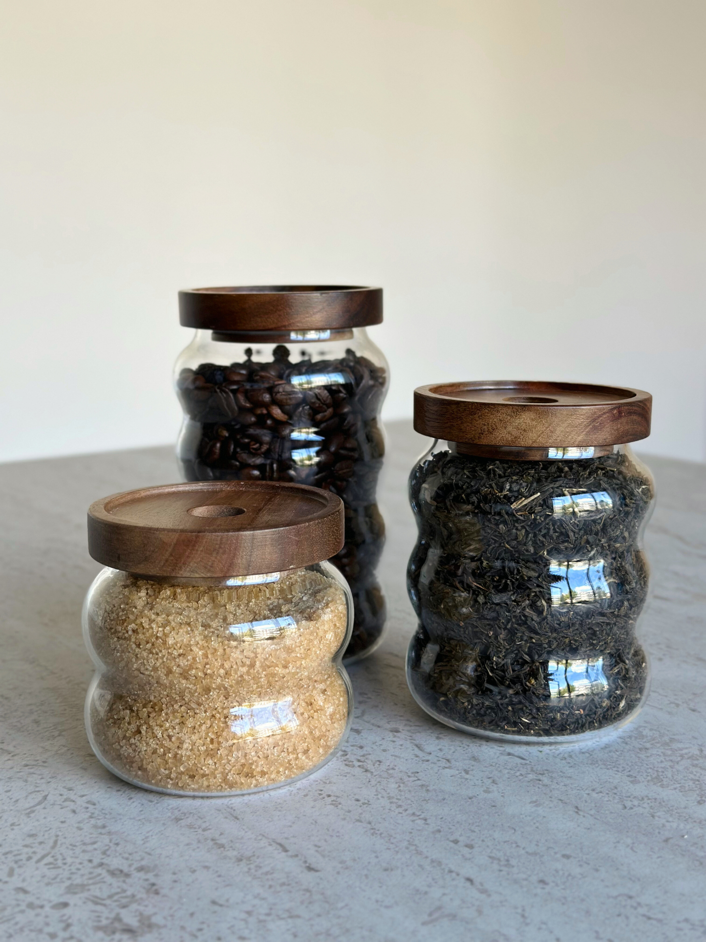 wavy round storage jar acacia lid; round storage jar with wavy shape; storage jar glass wavy; storage jar with acacia wooden lid; storage jar brown lid; storage jar with natural wooden lid; storage jar airtight; storage jar stylish design; storage jar with screw lid; storage jar transparent; storage jar kitchen organize; storage jar set; storage jar small and large; storage jar with label; storage jar bamboo alternative; storage jar kitchen cabinet; storage jar sustainable material; storage jar IKEA; storag