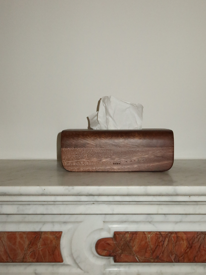 Handmade Borneo wooden tissue box holder crafted from natural, durable wood with a rich dark brown finish. This luxury wooden tissue holder features a minimalist design with a fitted lid, designed to neatly store standard tissue boxes while enhancing a calm and organized interior. A stylish and sustainable wooden tissue box organizer that complements both bathroom and living room spaces, adding warmth, elegance, and a natural look. An elegant Borneo wood accessory. 