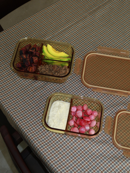 Zad is an amber-colored glass container with a glass lid and refined amber/brown accents, combining style and functionality. The integrated glass divider keeps multiple ingredients organized. Perfect for balanced lunches, meal prep, or storing leftovers. Non-toxic, BPA-free, odor- and stain-resistant glass makes it durable, easy to clean, leak-proof, and ideal for mindful, stylish storage in kitchen, fridge, or lunch bag.