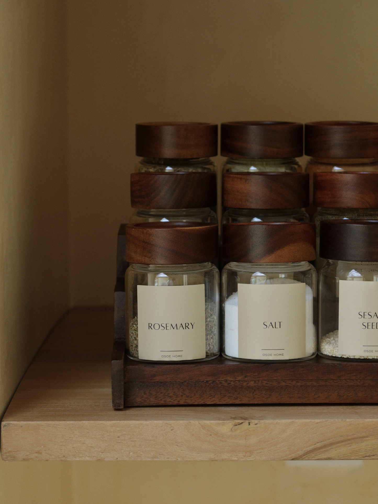 Dark brown wooden spice rack Calum for organizing up to 15 Osoe Home spice jars in a stylish and organized way, designed as a functional kitchen organizer for countertops or cabinets, made from sturdy dark wood with a minimalist and timeless design that creates a calm and elegant kitchen aesthetic, perfect for modern spice storage, pantry organization and creating a PFAS-free, BPA-free and microplastic-free kitchen environment with clutter-free kitchen styling.