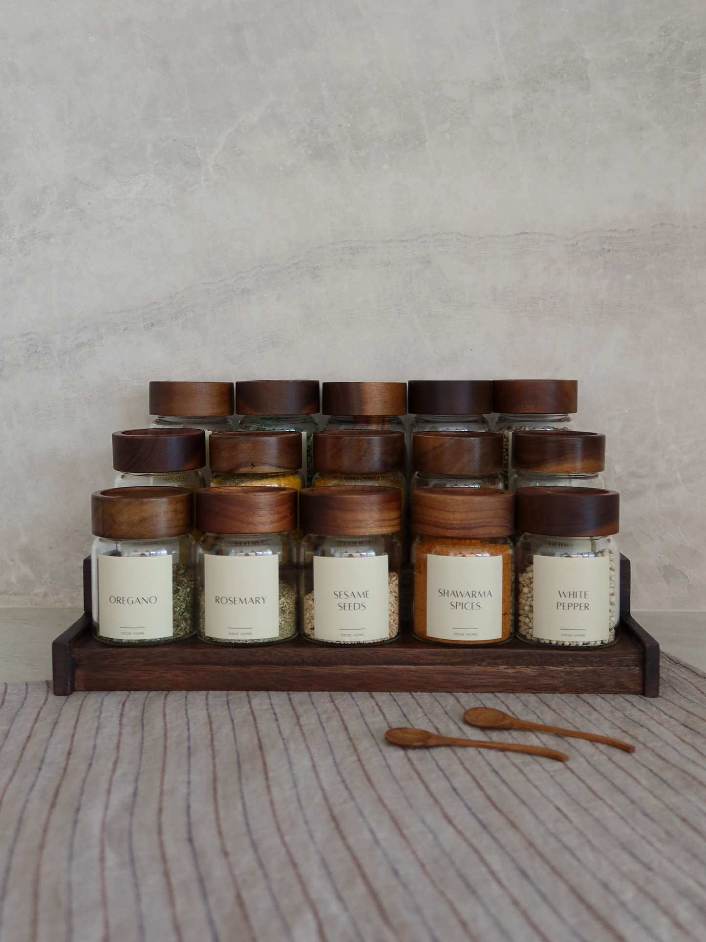 Dark brown wooden spice rack Calum for organizing up to 15 Osoe Home spice jars in a stylish and organized way, designed as a functional kitchen organizer for countertops or cabinets, made from sturdy dark wood with a minimalist and timeless design that creates a calm and elegant kitchen aesthetic, perfect for modern spice storage, pantry organization and creating a PFAS-free, BPA-free and microplastic-free kitchen environment with clutter-free kitchen styling.