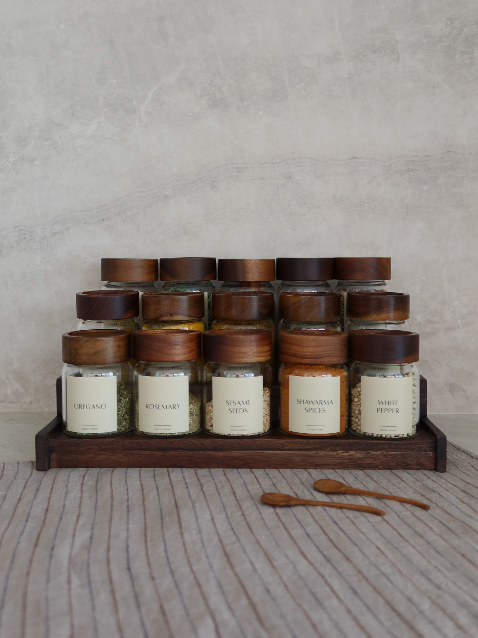 Dark brown wooden spice rack Calum for organizing up to 15 Osoe Home spice jars in a stylish and organized way, designed as a functional kitchen organizer for countertops or cabinets, made from sturdy dark wood with a minimalist and timeless design that creates a calm and elegant kitchen aesthetic, perfect for modern spice storage, pantry organization and creating a PFAS-free, BPA-free and microplastic-free kitchen environment with clutter-free kitchen styling.