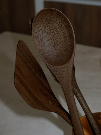 Handcrafted wooden kitchen utensil set in a rich dark brown finish, including six spoons and spatulas for everyday cooking, mixing, stirring, turning and serving. Made from durable SVLK-certified wood sourced from Indonesia and suitable for food contact. A natural, non-toxic and plastic-free choice for a more conscious kitchen. The timeless design complements modern, Scandinavian, rustic and farmhouse kitchens while adding a warm, refined touch to your cooking space.
