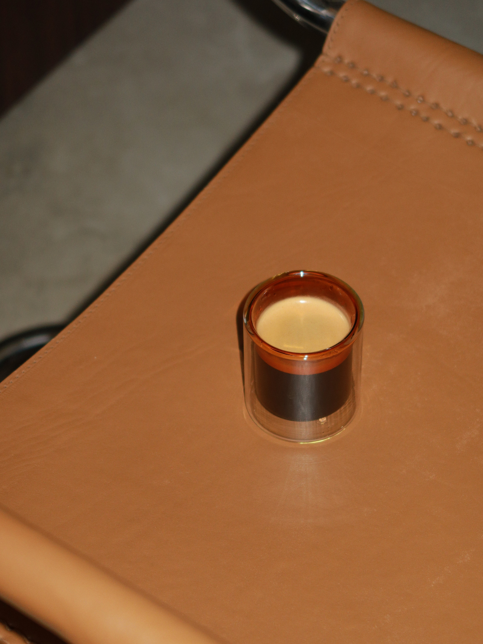 Straight espresso glass in a warm cognac brown tone, ideal for serving espresso shots or other coffee beverages. The elegant, minimalist design adds a luxurious touch to your coffee moments and fits beautifully in a modern, stylish kitchen or coffee corner. Made from durable glass for daily use, offering a sustainable and aesthetic reusable drinking experience.