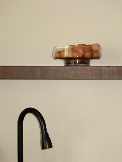 An elegant base for your fruit, Glass Bowl Shin is a spacious, large glass bowl perfect for displaying fruit in a natural and stylish way. Its clear, glass-like appearance highlights everything inside, from juicy apples to colorful citrus, making your presentation stand out. With soft curves and a minimalist design, Shin doubles as a decorative object. Made from clear, durable borosilicate glass, it is strong yet lightweight, adding a fresh and elegant touch to any table or kitchen.