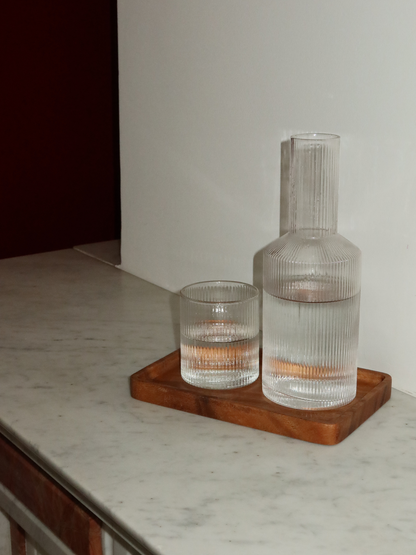 Kan Neko, an elegant water or juice pitcher with a subtle ribbed texture that beautifully captures light and shadow. Perfect for serving water, juice, or other refreshing drinks in style. Made from durable, clear borosilicate glass—strong and heat-resistant—with a handy shape that makes filling and pouring easy. The ribbed structure adds a unique, playful touch without being overpowering. Pair Neko with matching glasses (sold separately) for a complete and stylish set