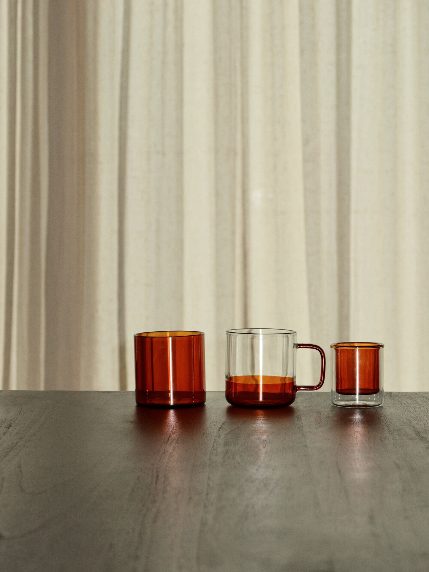 Straight espresso glass in a warm cognac brown tone, ideal for serving espresso shots or other coffee beverages. The elegant, minimalist design adds a luxurious touch to your coffee moments and fits beautifully in a modern, stylish kitchen or coffee corner. Made from durable glass for daily use, offering a sustainable and aesthetic reusable drinking experience.