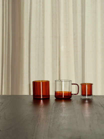 Straight espresso glass in a warm cognac brown tone, ideal for serving espresso shots or other coffee beverages. The elegant, minimalist design adds a luxurious touch to your coffee moments and fits beautifully in a modern, stylish kitchen or coffee corner. Made from durable glass for daily use, offering a sustainable and aesthetic reusable drinking experience.