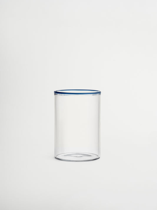 Glass Woojin, a fully transparent glass cup with a subtle blue rim that adds a stylish and unique touch to any beverage. Perfect for iced coffees, water, juices, matcha, or other refreshing drinks. Made from durable borosilicate glass with a minimalist, modern, and elegant design. Ideal for aesthetic table settings, sustainable kitchenware, and reusable glass drinkware.