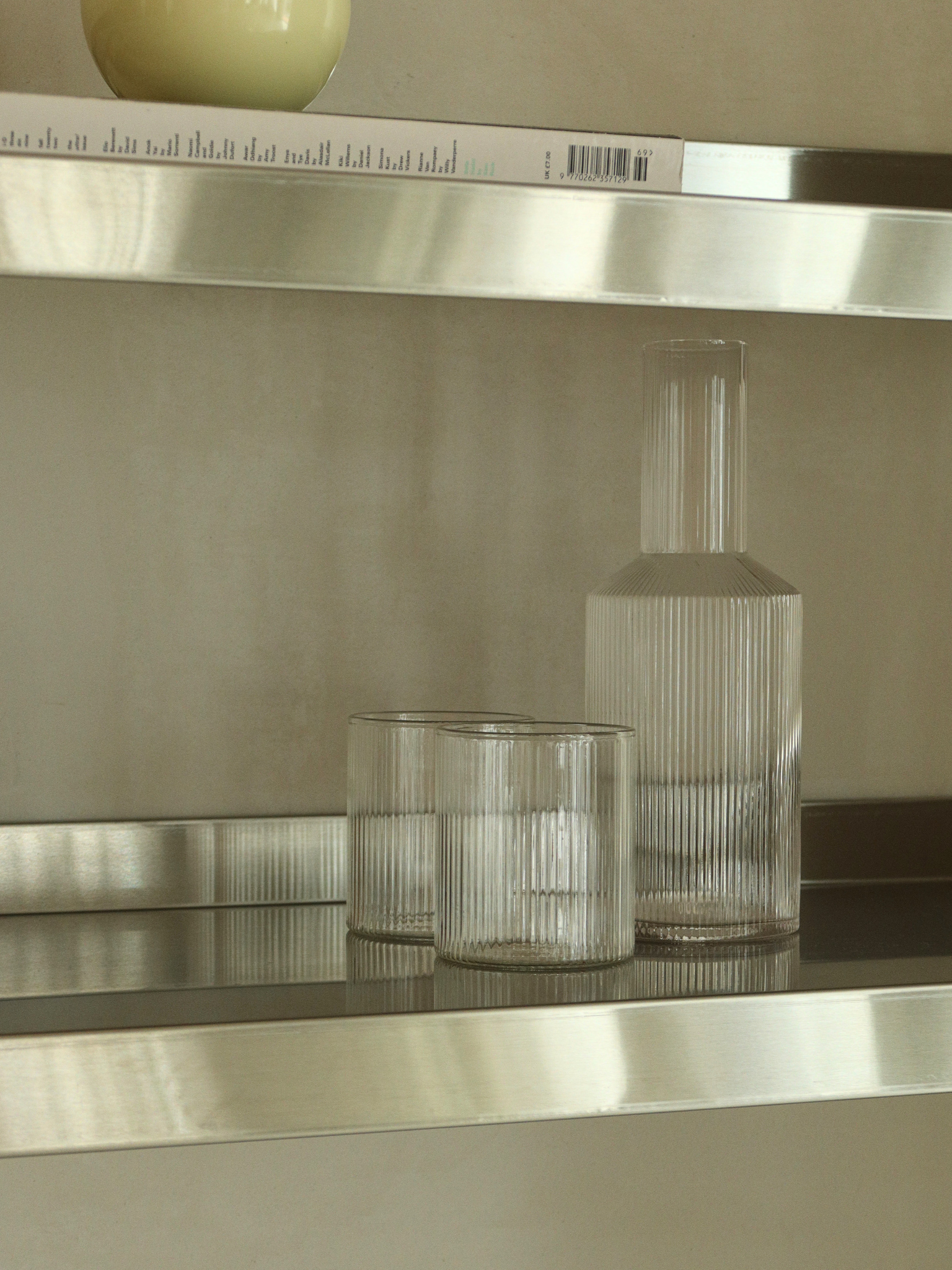 Glass water jug Neko with a subtle ribbed texture, made from clear and durable borosilicate glass. The elegant ridges beautifully catch the light, adding a refined and playful touch to the minimalist design. Perfect for serving water, juice and other refreshing drinks. The strong, heat-resistant glass and easy-to-hold shape make Neko practical for everyday use. Pair the glass jug with matching glasses for a stylish table setting, or use it on its own as an elegant water pitcher.