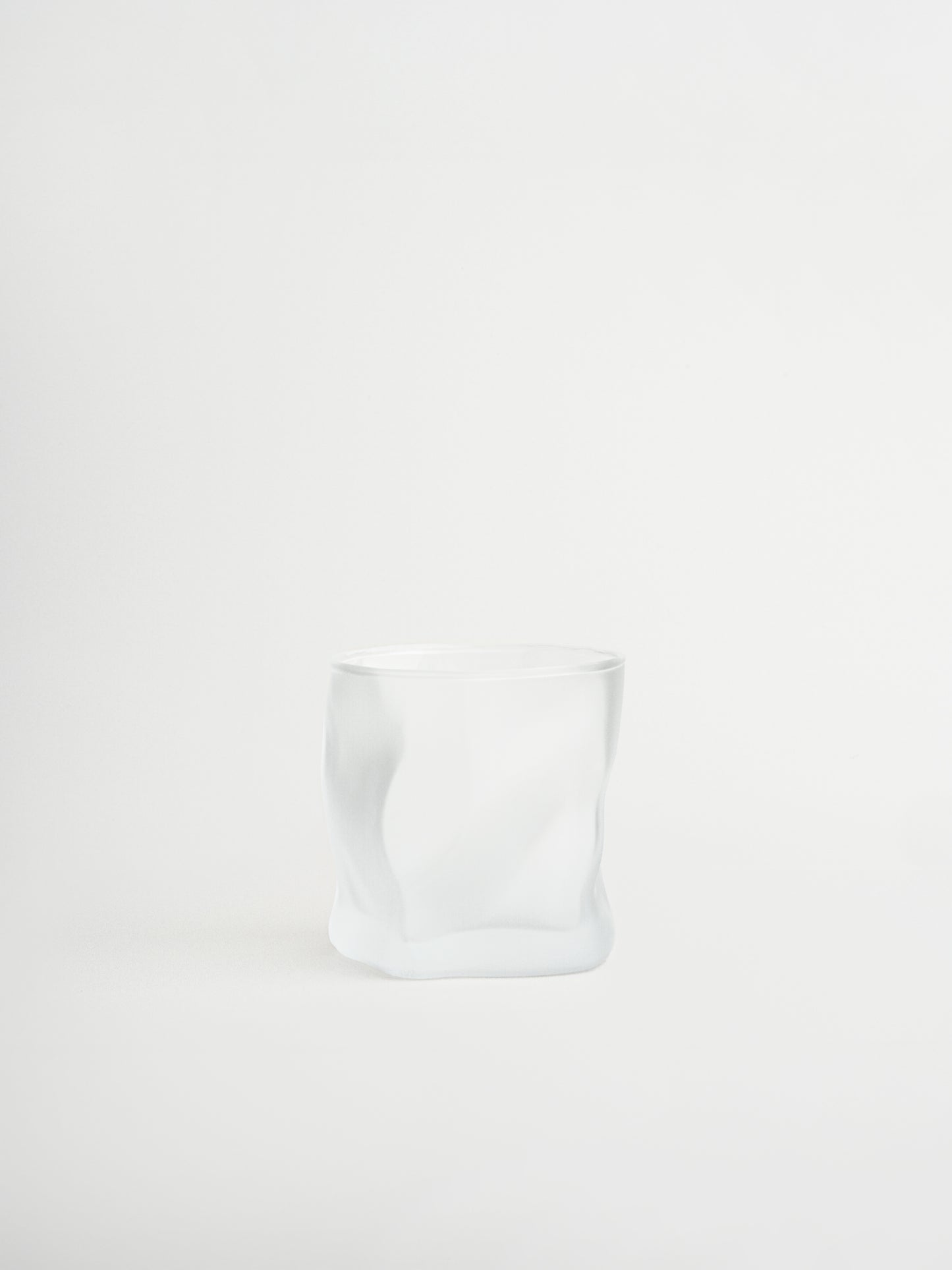 Glass tumbler Roca with a unique rock-shaped design for stylish serving of water, cocktails and other beverages, made from durable and sturdy glass with a matte finish that creates a modern and striking look, designed for a comfortable grip and a cohesive glassware collection to replace mismatched glasses, perfect for minimalist and elegant table styling and ideal for everyday use while creating a consistent and elevated drinking experience at home.