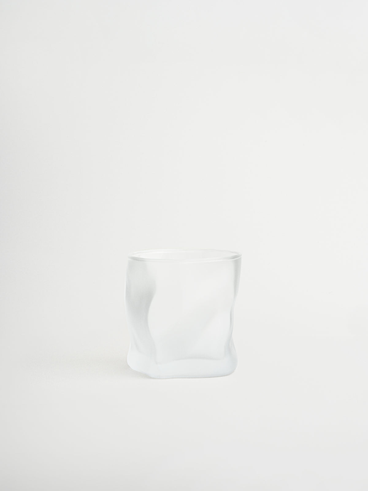 Glass tumbler Roca with a unique rock-shaped design for stylish serving of water, cocktails and other beverages, made from durable and sturdy glass with a matte finish that creates a modern and striking look, designed for a comfortable grip and a cohesive glassware collection to replace mismatched glasses, perfect for minimalist and elegant table styling and ideal for everyday use while creating a consistent and elevated drinking experience at home.