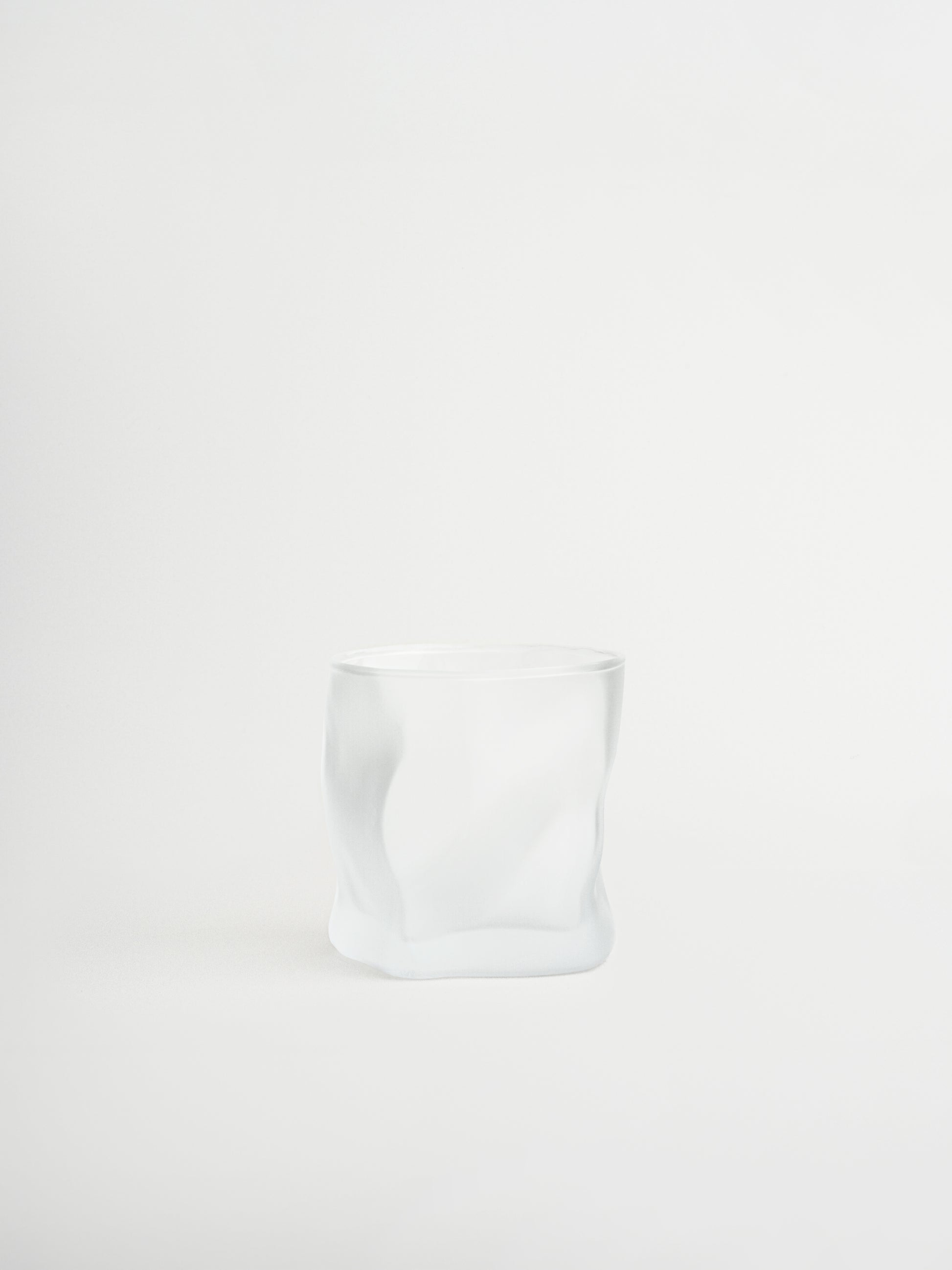 Glass tumbler Roca with a unique rock-shaped design for stylish serving of water, cocktails and other beverages, made from durable and sturdy glass with a matte finish that creates a modern and striking look, designed for a comfortable grip and a cohesive glassware collection to replace mismatched glasses, perfect for minimalist and elegant table styling and ideal for everyday use while creating a consistent and elevated drinking experience at home.