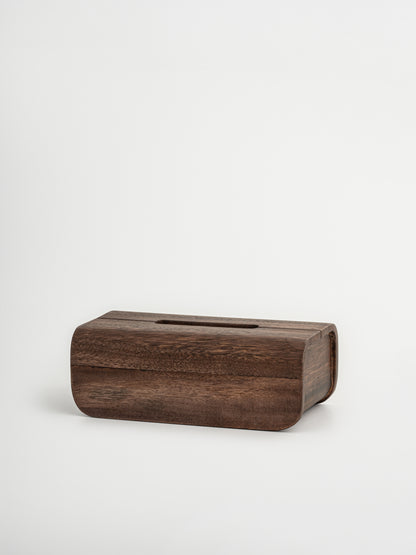 Handmade Borneo wooden tissue box holder crafted from natural, durable wood with a rich dark brown finish. This luxury wooden tissue holder features a minimalist design with a fitted lid, designed to neatly store standard tissue boxes while enhancing a calm and organized interior. A stylish and sustainable wooden tissue box organizer that complements both bathroom and living room spaces, adding warmth, elegance, and a natural look. An elegant Borneo wood accessory. 