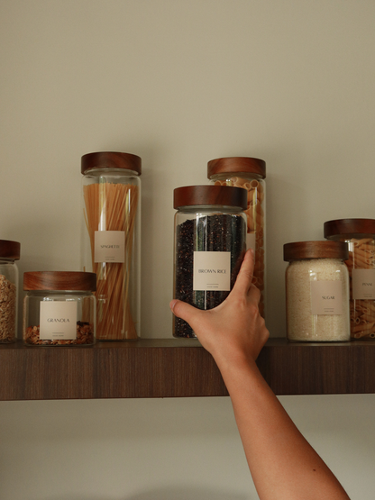 Jar Nara is designed for durability and everyday use. Made from extra-thick glass and finished with a solid acacia wood screw lid, this airtight storage jar protects dry foods while adding warmth to your kitchen shelves. Its minimalist design makes it easy to mix and match, and multiple size options allow you to organize your pantry efficiently. Elevate your kitchen storage with Jar Nara. The rich acacia wood lid and crystal-clear borosilicate-style glass create a luxurious yet natural aesthetic.