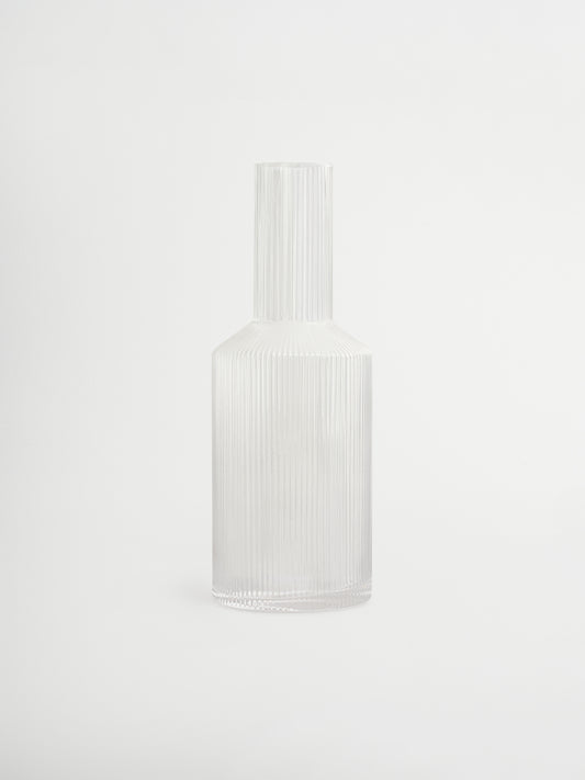 Kan Neko, een elegante water- of sapkan met subtiele ribbelstructuur die licht en schaduw prachtig vangt. Perfect om water, sap of andere verfrissende dranken stijlvol te serveren. Gemaakt van duurzaam, helder borosilicaatglas, stevig en hittebestendig, met een handzame vorm die gemakkelijk te vullen en schenken is. De ribbelstructuur geeft een unieke, speelse touch zonder te overheersen. Combineer Neko met bijpassende glazen (apart verkrijgbaar) voor een complete en stijlvolle set, of gebruik hem los als e