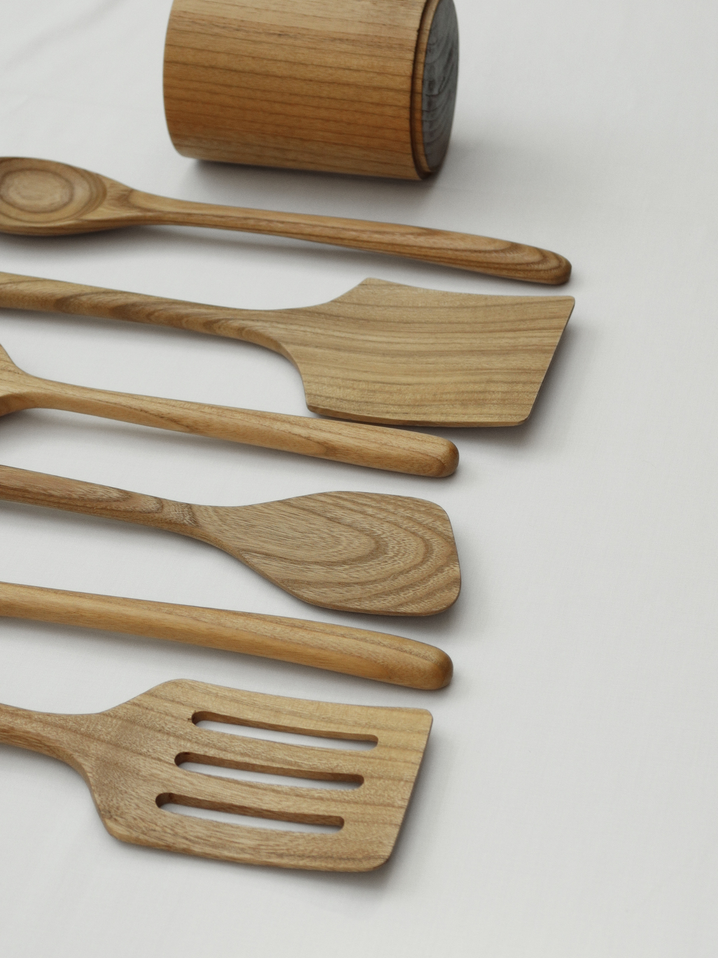 Organize your kitchen utensils with the Zarif utensil holder made from Asian oak wood, a stylish and functional cup for neatly storing spoons, spatulas and tongs, handcrafted from high-quality sustainable wood with a natural rustic look that fits any kitchen style, designed with a minimalist aesthetic and durable construction for long-lasting use, and suitable for a non-toxic kitchen free from BPA, PFAS and microplastics for a healthier and more organized cooking environment.