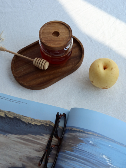 Round wooden organizing plate crafted from natural wood, designed as a stylish kitchen countertop tray for spice jars, oil and vinegar dispensers, soap dispensers, seasoning containers, and everyday kitchen accessories. This minimalist wooden organiser provides an elegant and durable storage solution for keeping countertops neat, organised, and clutter-free while complementing modern, Scandinavian, farmhouse, and rustic home décor.