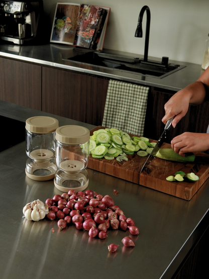 Clean, simple, and thoughtfully designed. With the Torshi pickle jar, there’s no more reaching into brine or awkwardly fishing for pickles. The clever glass insert allows you to lift and drain contents effortlessly, making serving hygienic and mess-free.
The soft beige finish adds a subtle, warm touch while keeping your refrigerator visually calm and organized. Designed to bring structure to everyday storage, Torshi helps group preserved foods neatly and keeps ingredients fresh and easy to access.