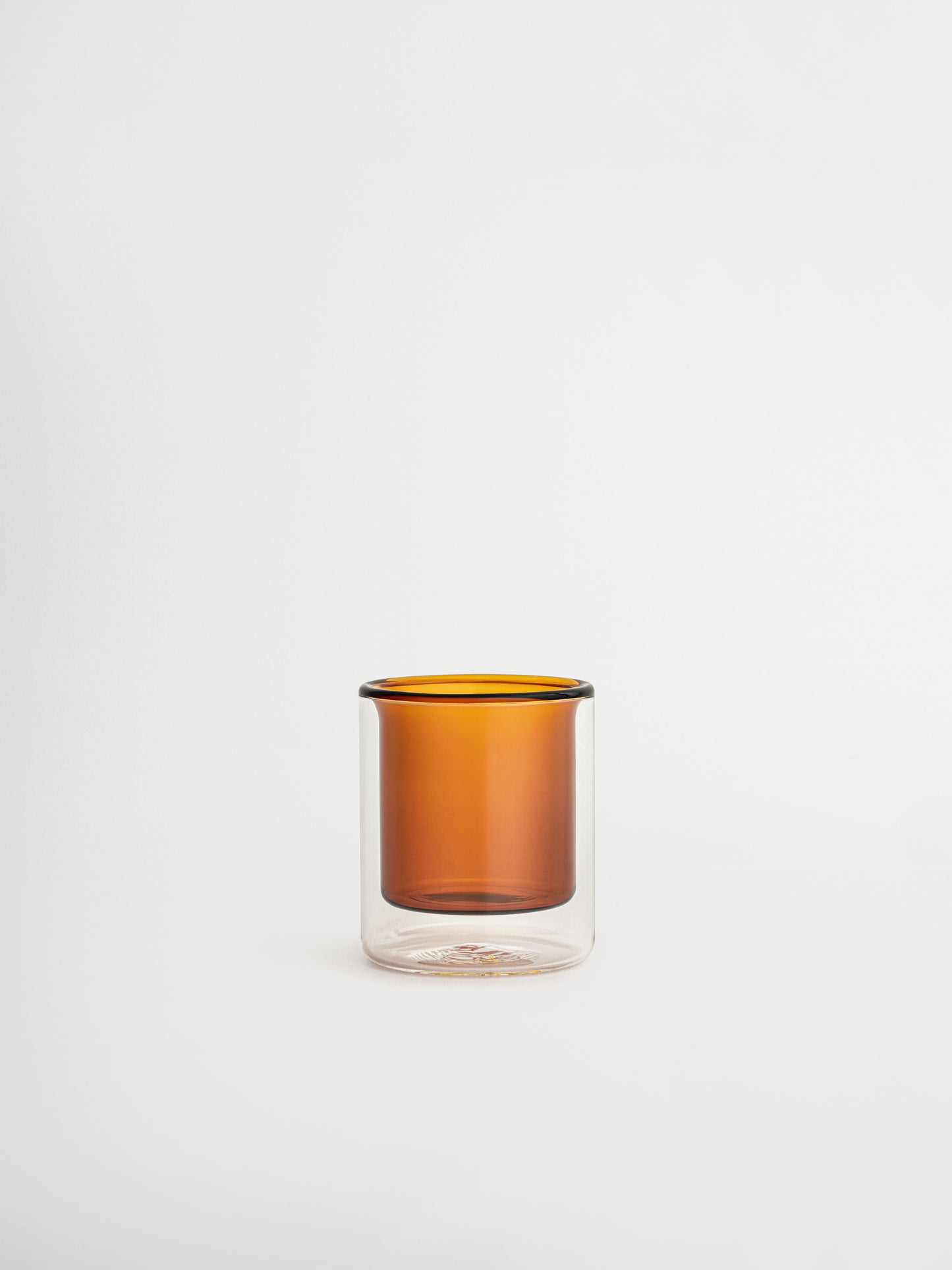 Straight espresso glass in a warm cognac brown tone, ideal for serving espresso shots or other coffee beverages. The elegant, minimalist design adds a luxurious touch to your coffee moments and fits beautifully in a modern, stylish kitchen or coffee corner. Made from durable glass for daily use, offering a sustainable and aesthetic reusable drinking experience.