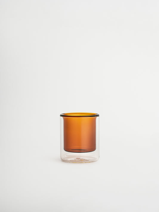 Straight espresso glass in a warm cognac brown tone, ideal for serving espresso shots or other coffee beverages. The elegant, minimalist design adds a luxurious touch to your coffee moments and fits beautifully in a modern, stylish kitchen or coffee corner. Made from durable glass for daily use, offering a sustainable and aesthetic reusable drinking experience.