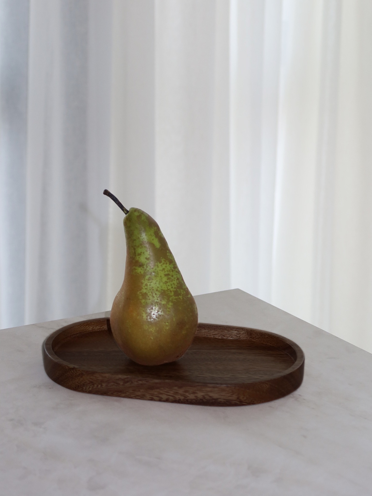 Dark brown oval wooden organizer tray, perfect for stylishly organizing dispensers, perfume bottles, spice jars, beauty products and other small essentials around the home. The warm natural wood grain adds an elegant and calming touch to any space. Use this wooden tray as a kitchen counter organizer, bathroom tray or decorative surface for your favorite bottles and accessories. A timeless and versatile home accessory for creating a more organized, minimalist space.