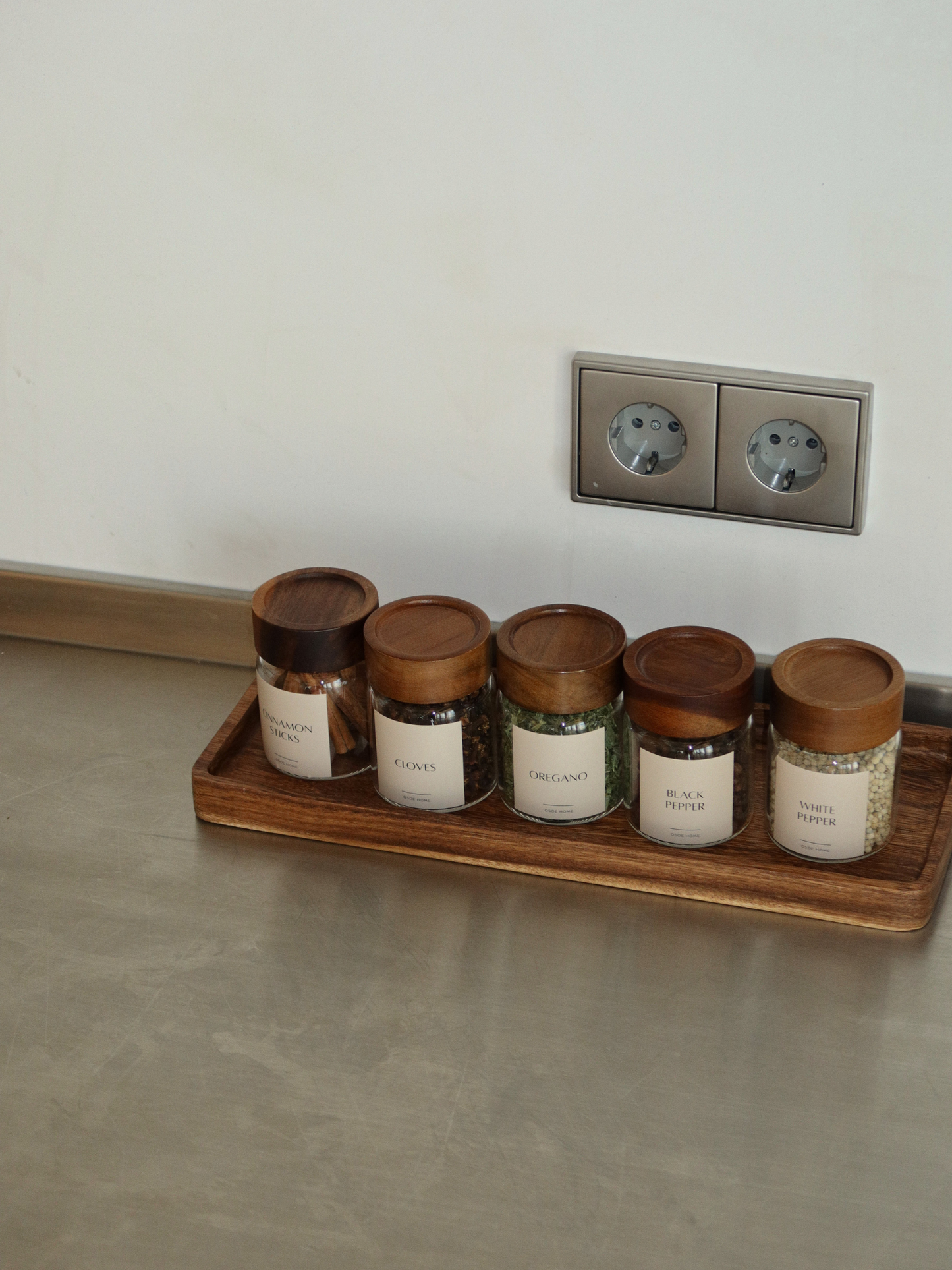 Dark brown rectangular wooden organizer tray Amara, available in two sizes, perfect for organizing spice jars, dispensers, soap and other small essentials. This versatile wooden tray can also be used as a coaster for kitchen accessories, a small bread board or a stylish base for items in the kitchen, bathroom or on the dining table. The warm natural wood grain adds a timeless, elegant touch and fits beautifully into a calm, minimalist interior. A practical and stylish wooden organizer.