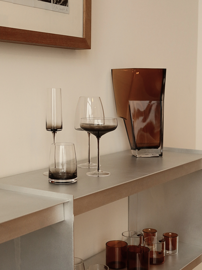 Verre tumbler Izzah avec un élégant effet ombré allant du brun foncé au verre transparent, parfait pour servir de l’eau, du jus ou d’autres boissons rafraîchissantes avec style. Son design minimaliste et épuré apporte une ambiance raffinée, digne d’un restaurant, à votre table ou coffee corner. Fabriqué en verre durable et réutilisable, idéal pour une vaisselle esthétique, les cuisines modernes et une décoration de table élégante.