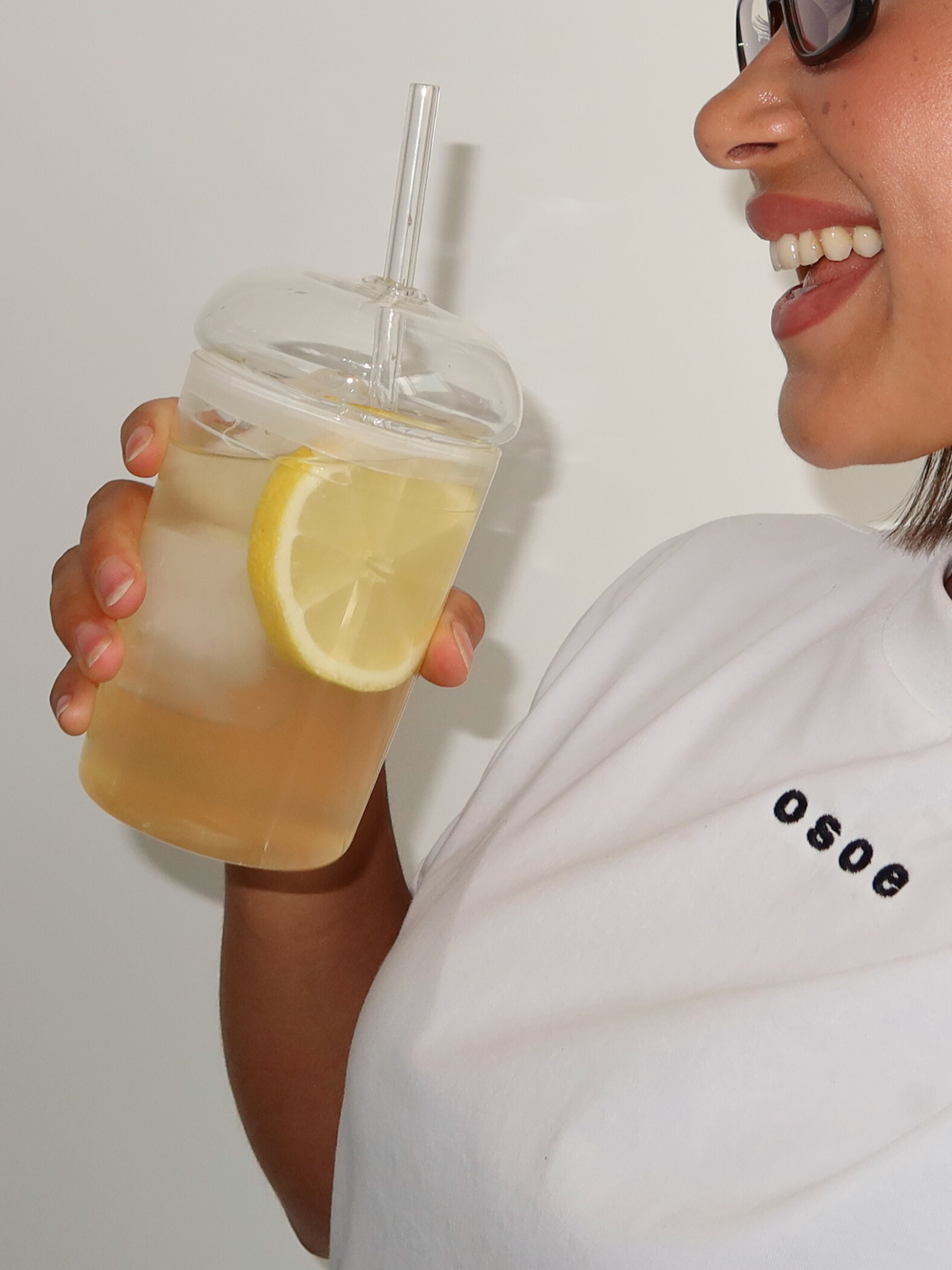 Glass cup, glass straw, clear drinkware, minimalist design, eco-friendly, reusable straw, modern tableware, transparent glass, natural light, home organization, clutter-free, tidy space, kitchen aesthetics, sustainable lifestyle, simple decor, functional kitchenware, stylish beverage, organized living, peaceful environment, elegant glassware, curated home, clean surface, thoughtful design, eco-conscious, calm ambiance.